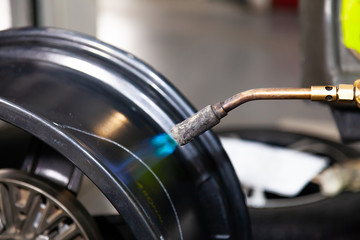 The process of repairing an automobile wheel using a special press on a machine for straightening...