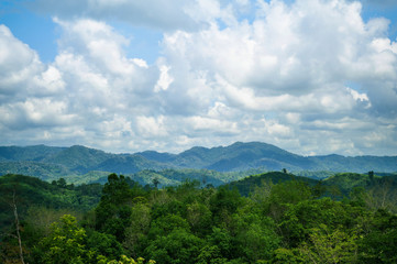 Morning green mountains, isolated on a bright sky background, at Narathiwat, Thailand