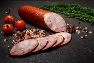 big chunk of smoked ham sausage with dill and tomatoes