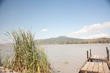 Landscape of Lake Patzcuaro Michoacan Mexico Short bridge next to grass and lake