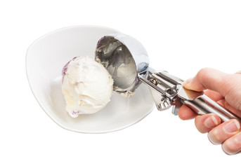 Fototapeta na wymiar putting ball of ice cream in bowl by disher scoop