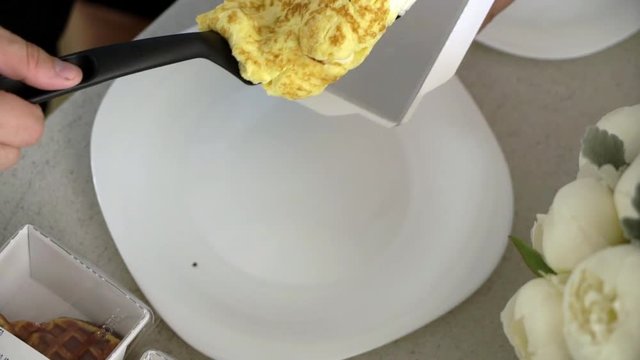 Man cooking breakfast at the kitchen