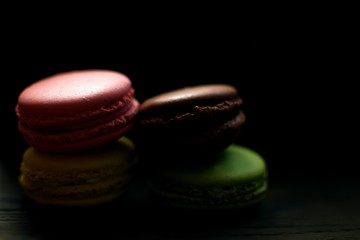Multi-colored macaroons on a wooden tray. Pink, yellow and green macaroon. - 272862588