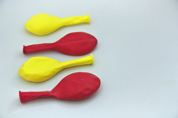 Red and yellow balloons on a white table