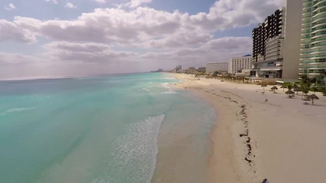 Aerial view on Chac Mool beach and turquoise water in Caribbean Sea. Resorts on Coast in Cancun, Mexico 