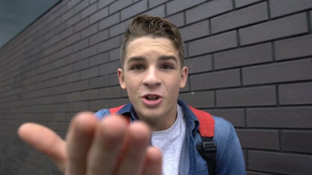 Teenager bullying, mucking about into camera, social condemnation, victim POV