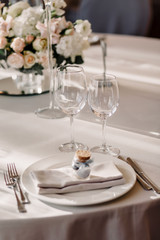 Wedding in the style vintage. Decoration of the table with flowers and cutlery. Composition from flowers. Elegant dining table in peach-purple color. Indoors wedding reception venue with festive decor