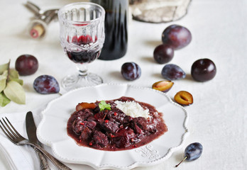 Beef Bourguignon  with plums. beef with red wine and plums,  stewed second course. dish with meat. 