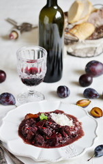 Beef Bourguignon  with plums. beef with red wine and plums,  stewed second course. dish with meat. 