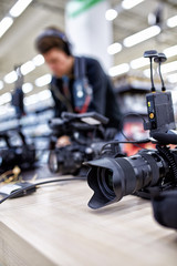 Obraz premium Videographer shooting a film or a television program in a studio with a professional camera, backstage