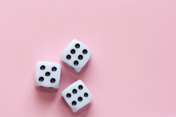 Gaming dices on pink background.