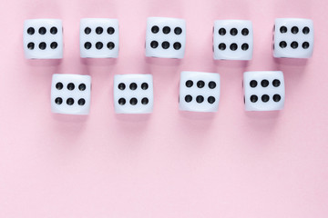 Gaming dices on pink background.