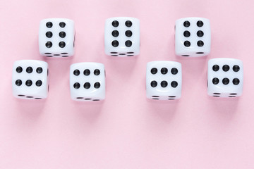 Gaming dices on pink background.