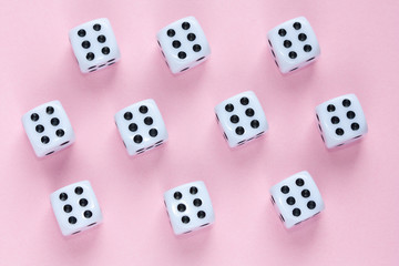 Gaming dices on pink background.