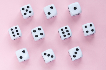Gaming dices on pink background.