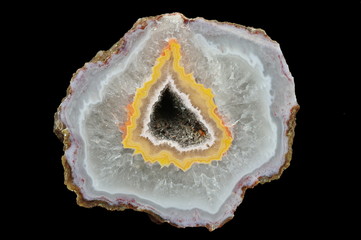 A cross-section of agate. Filled with quartz. In the center silica ring coloured by metal oxides and geode.