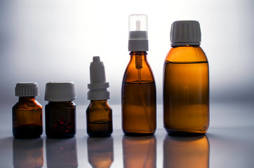Medical bottles with medicine on white background