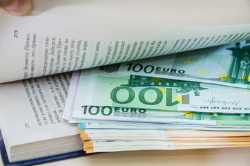 Euro in a book on the table, close-up