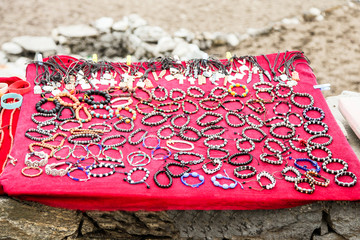 The red handmade table with the Souvenirs from Tibet in the mountain village in Nepal.