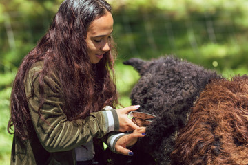 Young mixed race woman shears sheep wool on a farm © Jeremy Francis
