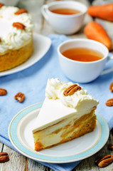 carrot cake cheesecake with pecan on a wood background