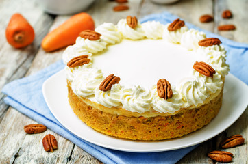 carrot cake cheesecake with pecan on a wood background