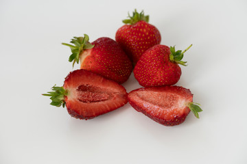 Red strawberry shot close-up on a white background. Isolate, macrophoto.