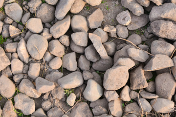 Brown stones background. Natural stones for background. Many stones lying on the ground. Abstract background.