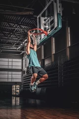 Foto op Canvas Black professional Black basketball player in action in a basketball court. © Fxquadro