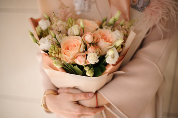 Lush bouquet of roses in peach wrapping