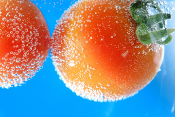 ripe tomato in water close-up