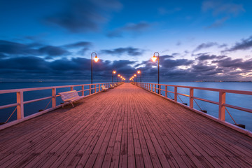 Illuminated wooden pier in Gdynia Orlowo.