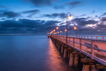 Naklejka premium Illuminated wooden pier in Gdynia Orlowo. Poland.