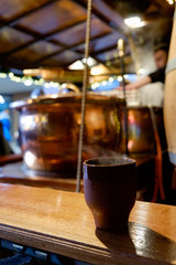 Pots of mulled wine in a stall in a Christmas market.