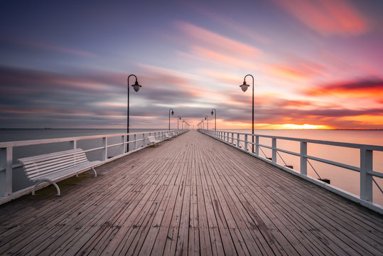 Fototapeta Wooden pier in Gdynia Orlowo in the morning with colors of sunrise. Poland. Europe.
