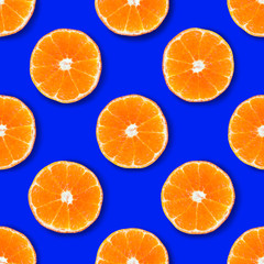 Seamless pattern made of tangerin on a bright blue background