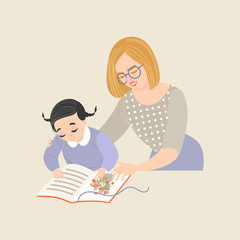 Young woman teaching little girl to read.