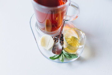 Hot tea in cafe with honey, spices, mint, lemon and ginger. Breakfast, relax concept