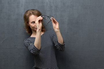 Obraz premium Portrait of girl looking with interest through glasses