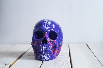 skull on the white wall and wood background