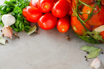 Preparation marinated conservation tomatoes with herbs, garlic, salt, and spice.