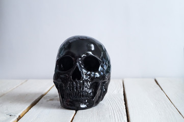 skull on the white wall and wood background