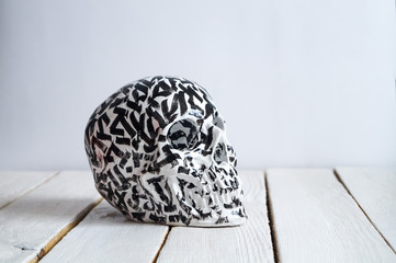 skull on the white wall and wood background