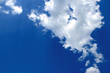 Fototapeta na wymiar White fluffy clouds against a blue sky.