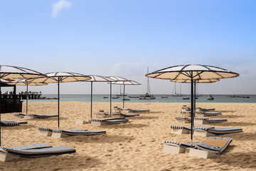 Beach with sun umbrellas and beds