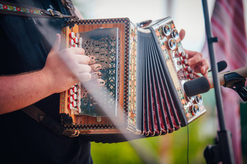 Hands playing on accordion