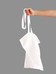 Fototapeta na wymiar young woman holding cotton bag 