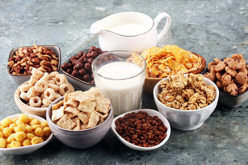 Cereal. Bowls of various cereals and milk for breakfast. Muesli with kids cereals.