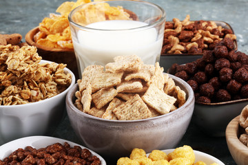 Cereal. Bowls of various cereals and milk for breakfast. Muesli with kids cereals.