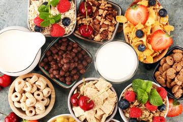 Cereal. Bowls of various cereals, berries and milk for breakfast. Muesli with kids cereals.